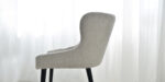 dining chair in light beige upholstery and black legs